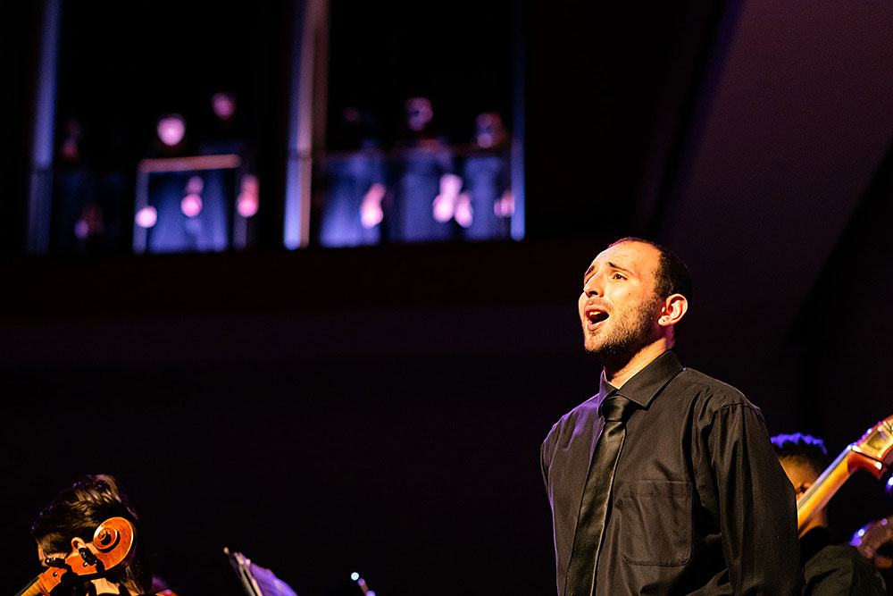 image of a man singing on stage