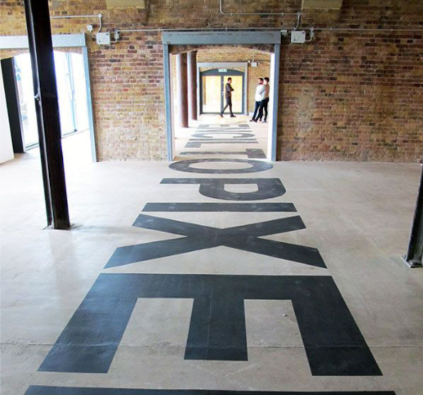 Text on the floor down a hallway