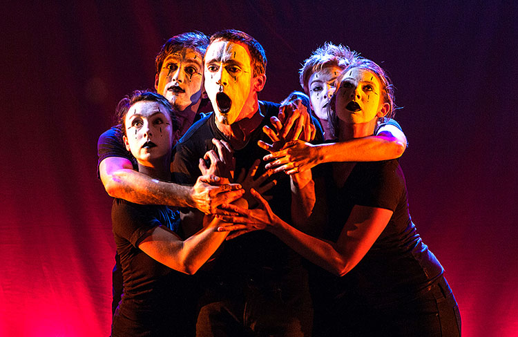 image of six mimes together on stage in a cluster