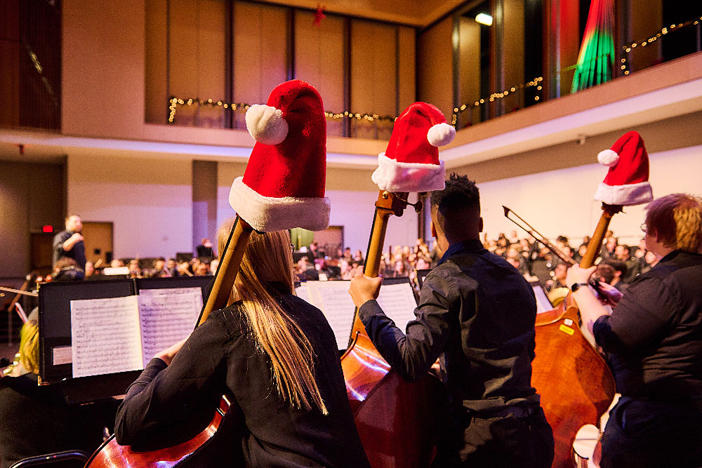 holiday concert with musicians wearing santa hats
