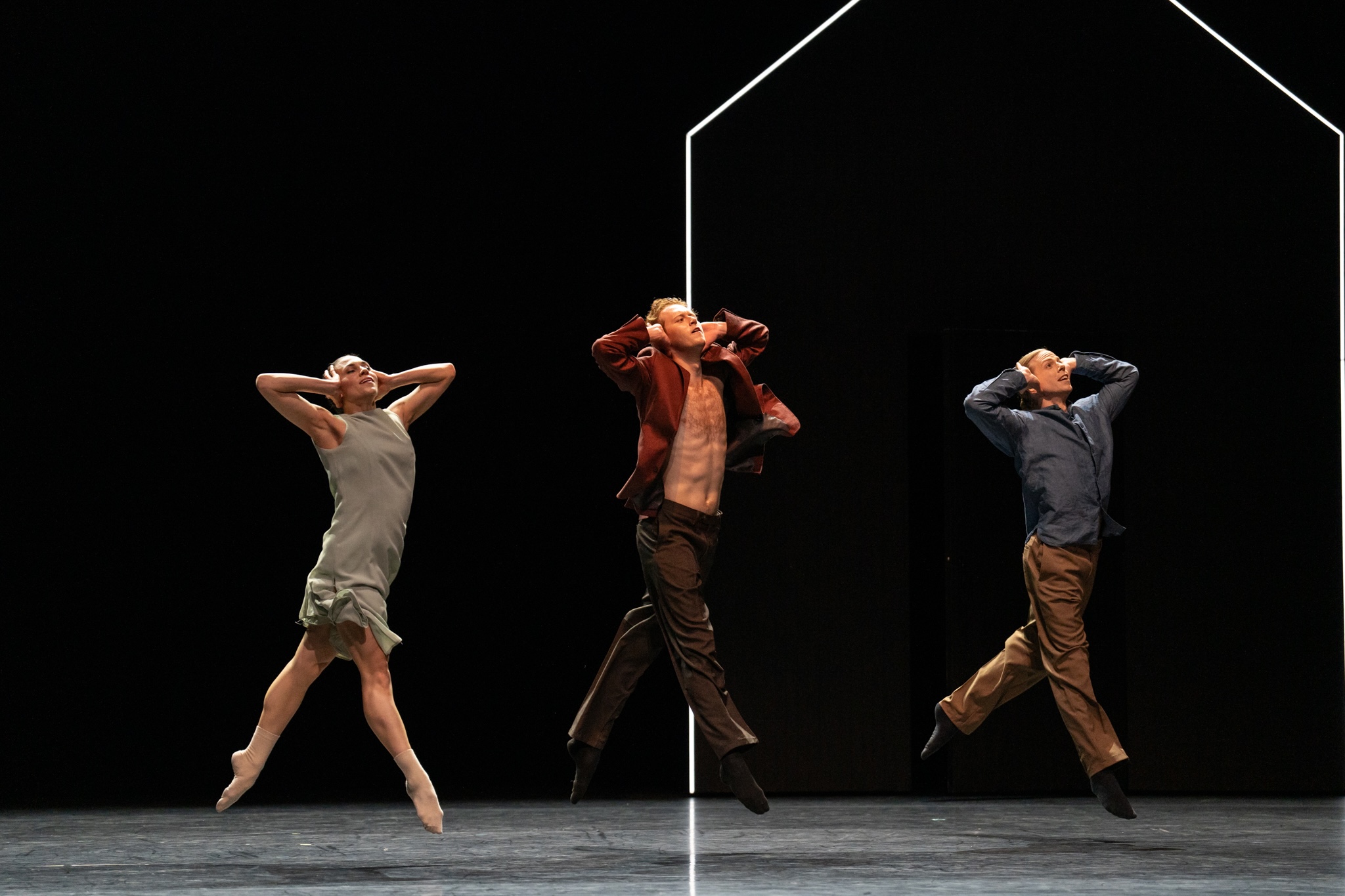 three dancers jump in synchronization