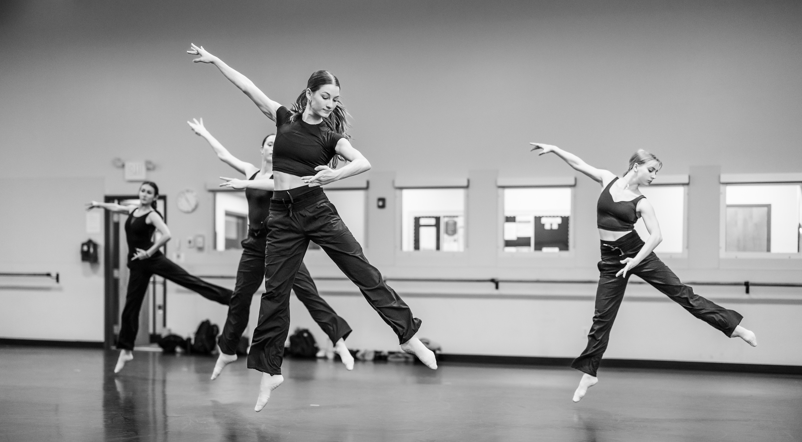 dancers leap synchronously into the air