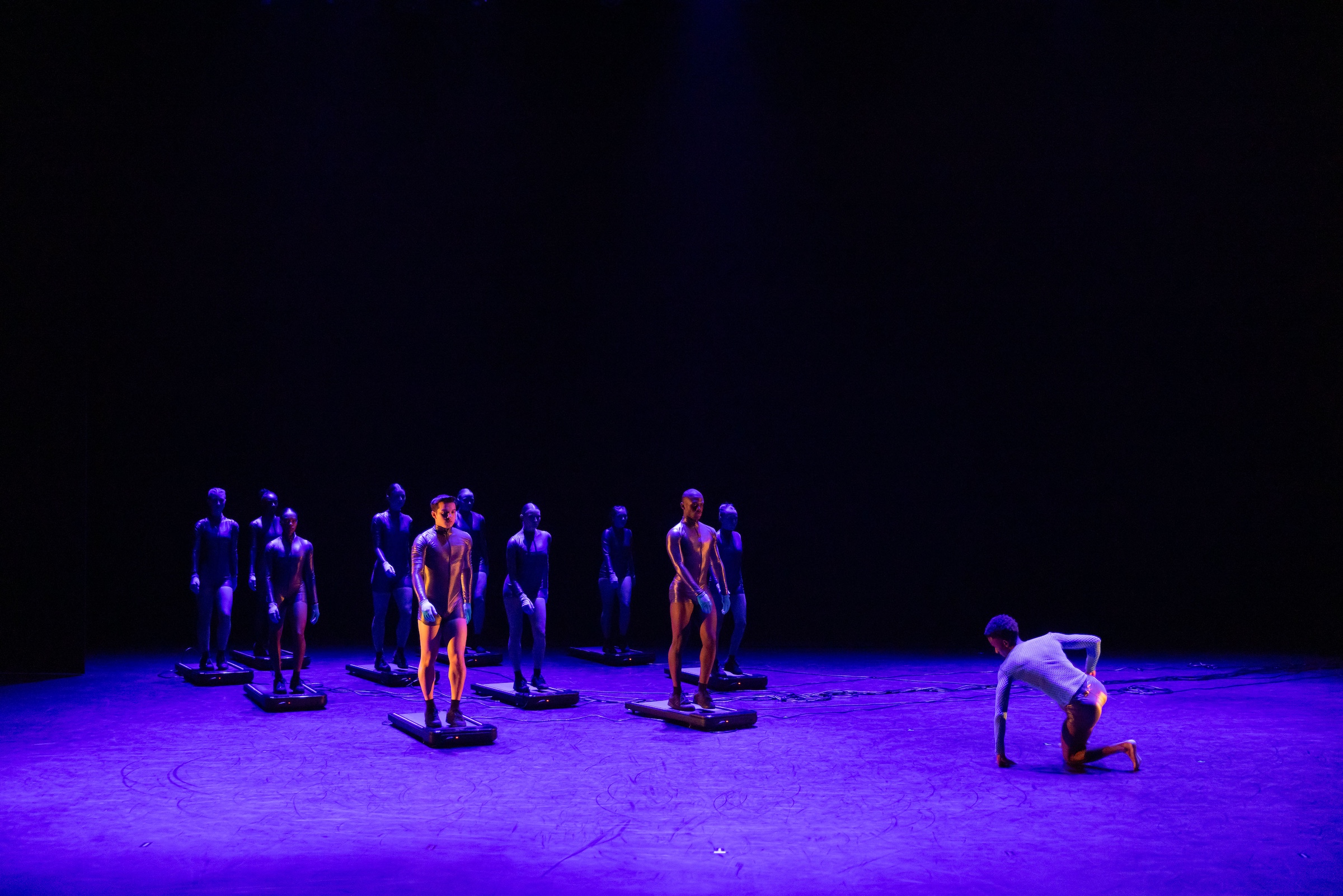 dancers dressed as futuristic androids perform a choreography as a part of labyrinth