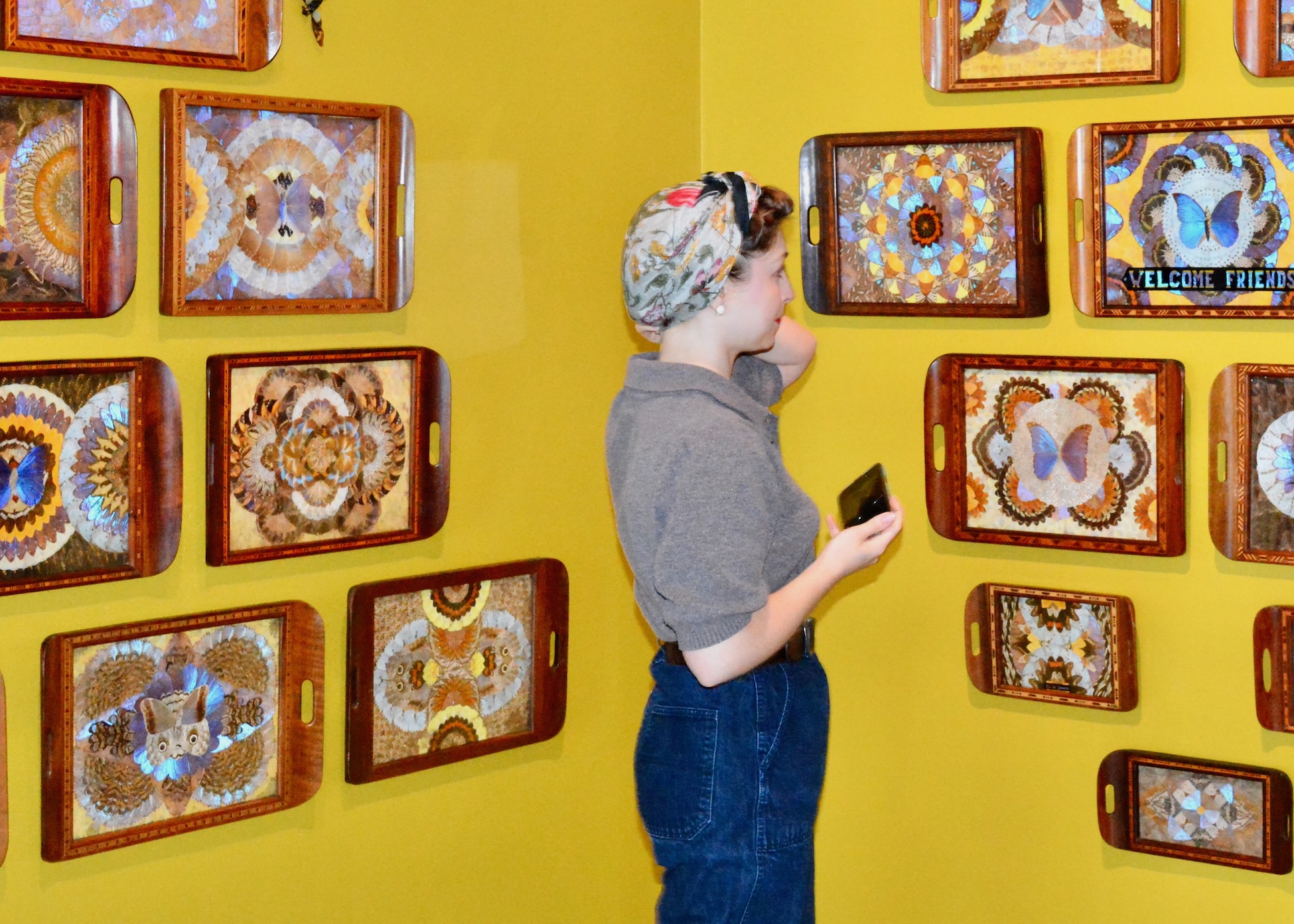 young woman enjoys looking at art in the Jennifer Angus Lady Bug exhibition at the ZMA