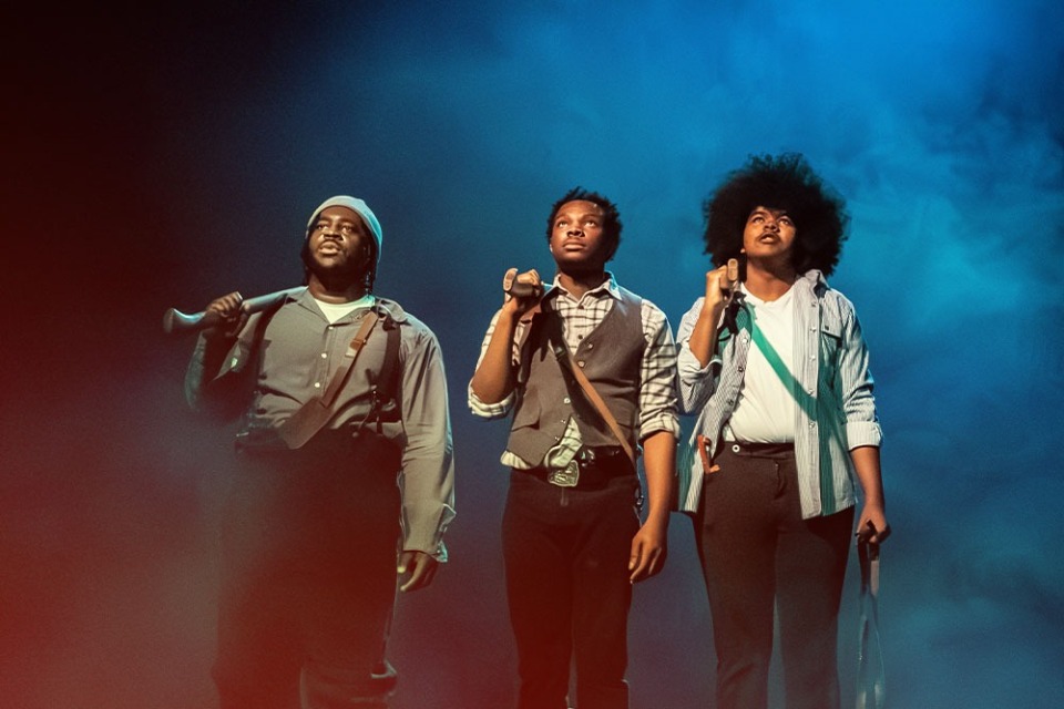 two female students in costume performing on stage