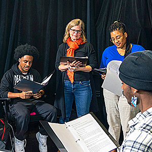 students in a circle reviewing material