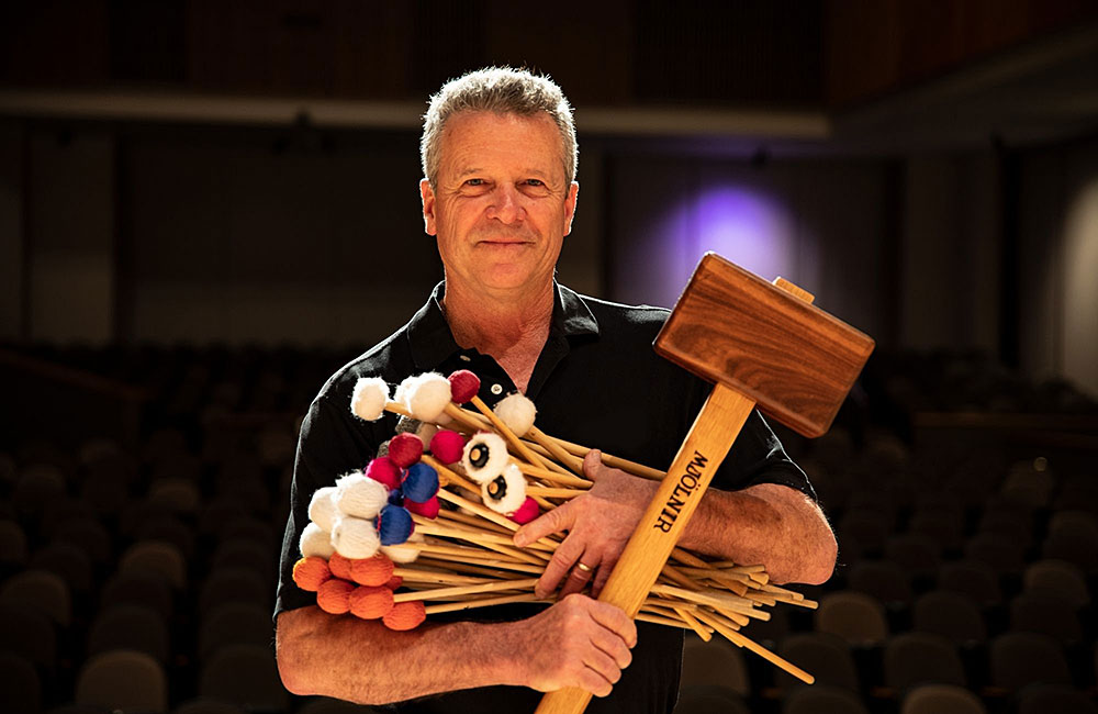 john lawless holding percussion instruments 