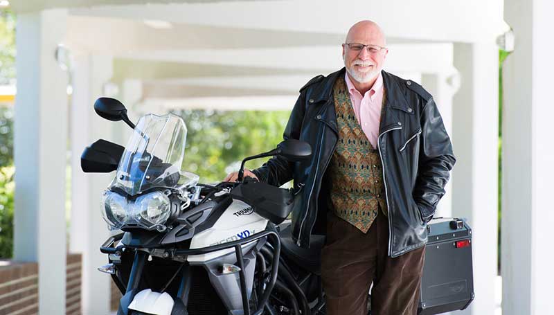 Harry Price posing with motorcycle