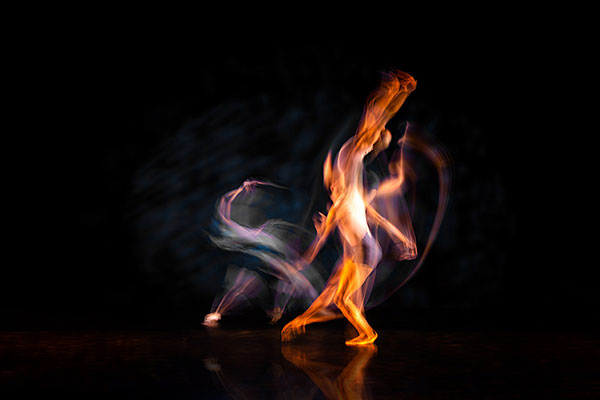 two dancers intertwined on stage