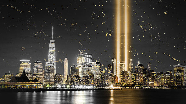 NYC skyline with beams of light where Twin Towers used to stand