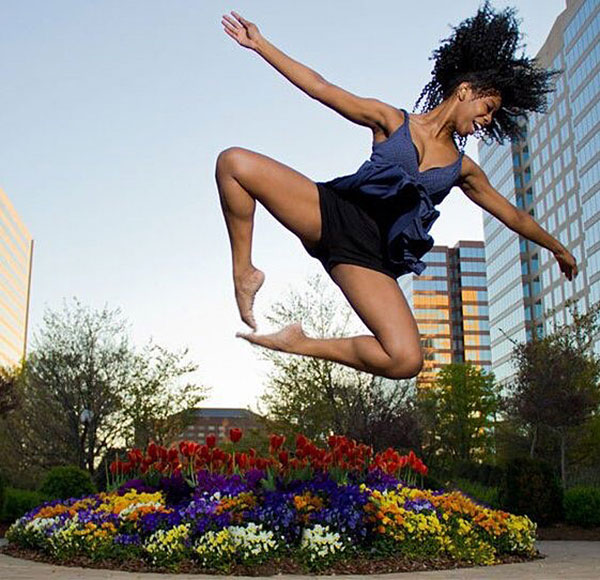 image of Camia Green dancing in front of Atlanta skyline