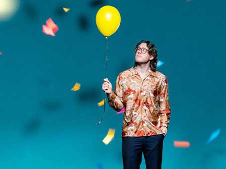 image of company man holding balloon 