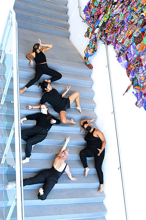 dancers on stairs respond to artwork