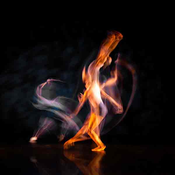  image of two dancers blurring on stage