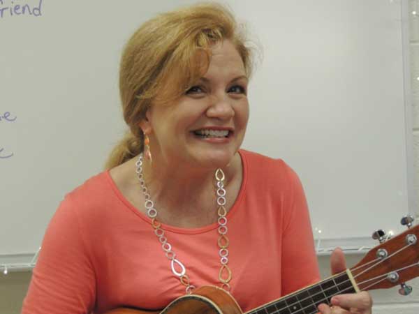Amber Weldon-Stephens playing instrument in classroom