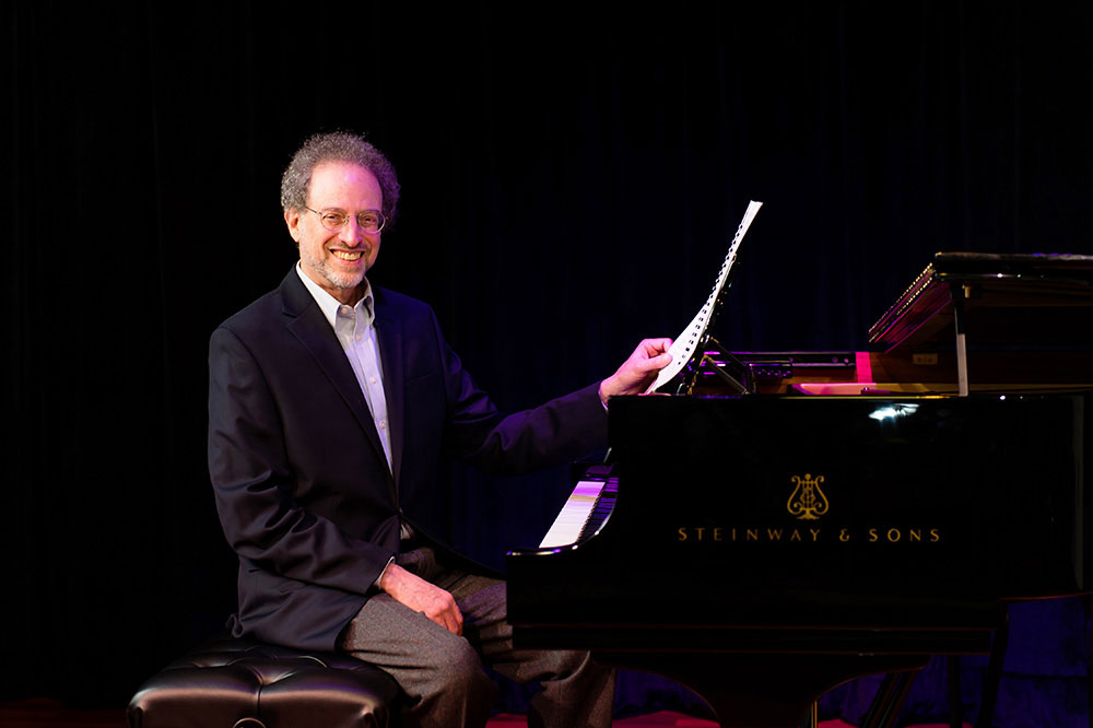 image of laurence sherr sitting at the piano