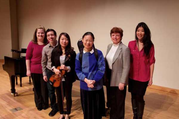 Midori posing with faculty and students