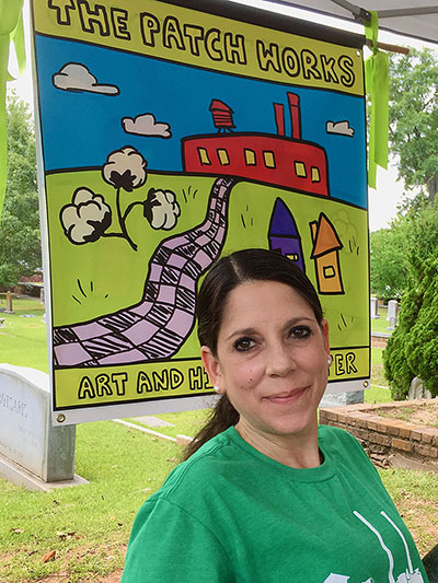 Nina Elsas in front of The Patch Works sign