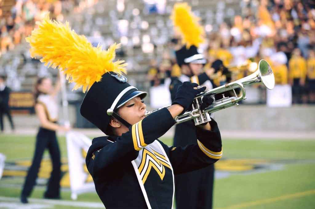 Rachel Ray playing instrument on field 