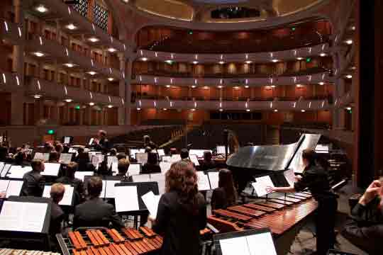 orchestra on stage in concert hall