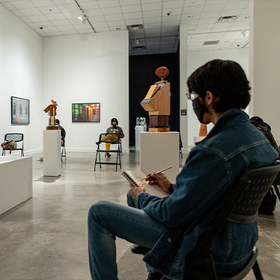 KSU student drawing in gallery