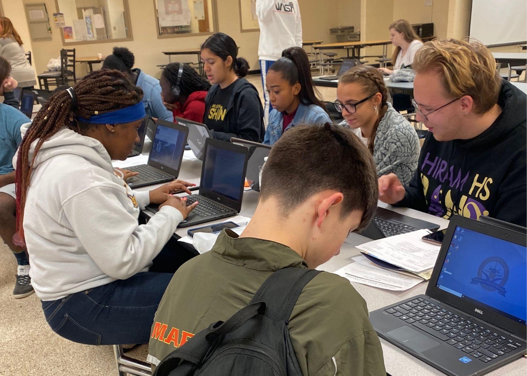 Students sitting at a table, using laptops. / Hiram High School Upward Bound begins registration and career planning.
