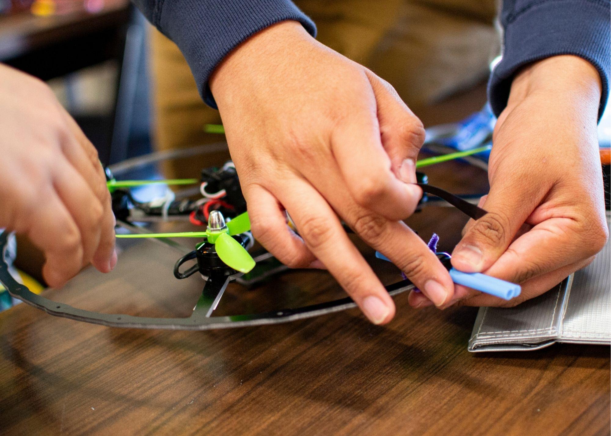 A pair of hands working on a drone / KSU TRIO's groundbreaking Drone Program introduces students to the basics of drone flying, ethics, and mechanics, and the program gives students the opportunity to test for their FAA Pilot's License