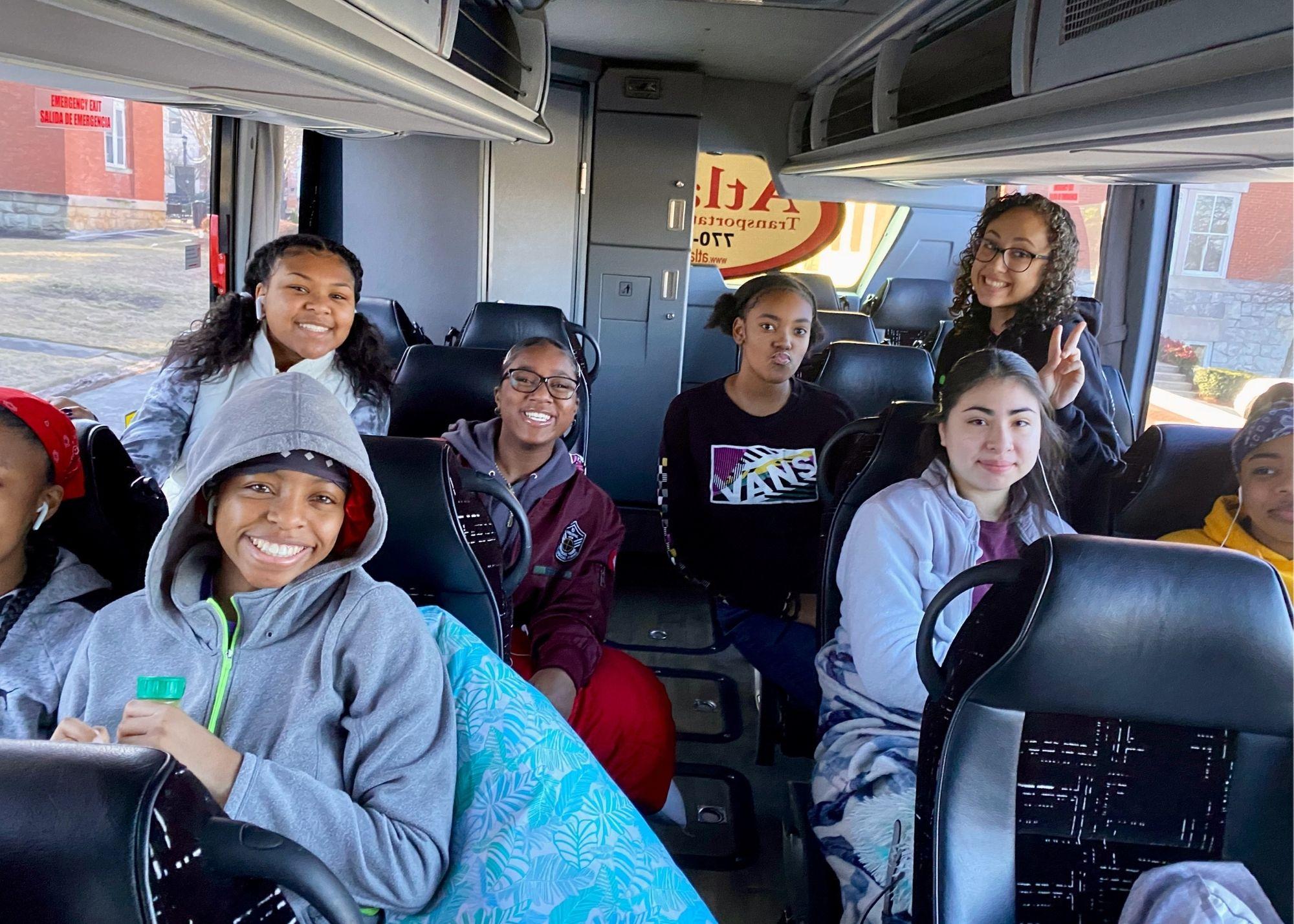 Students smiling while sitting on a bus / KSU TRIO Students have the opportunity to go on an out of state, educational field trip after full participation in the KSU TRiO Summer Academy. The trip is provided at no cost to students