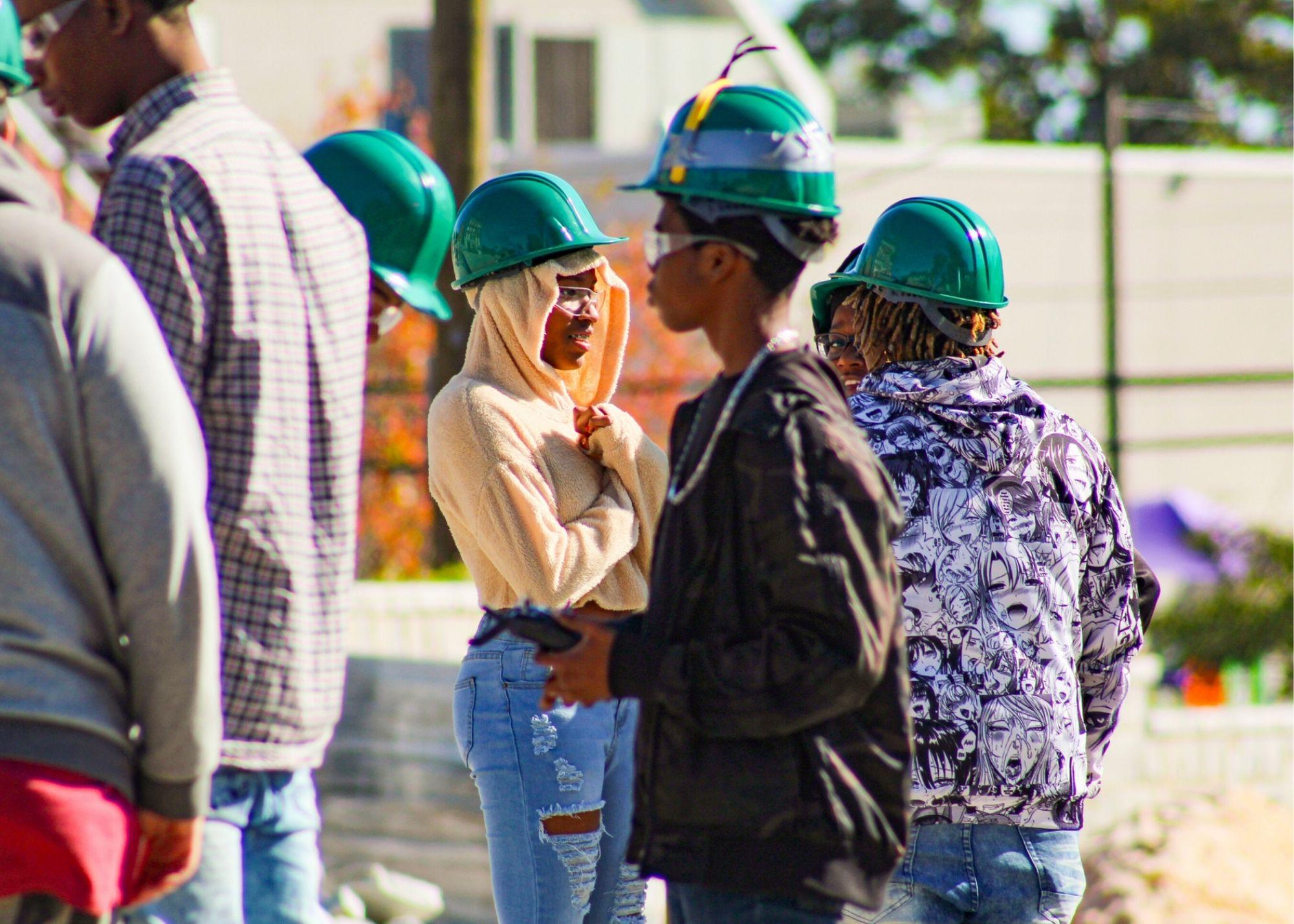 Students wearing hardhats learning about drone flying / KSU TRIO's groundbreaking Drone Program introduces students to the basics of drone flying, ethics, and mechanics, and the program gives students the opportunity to test for their FAA Pilot's License