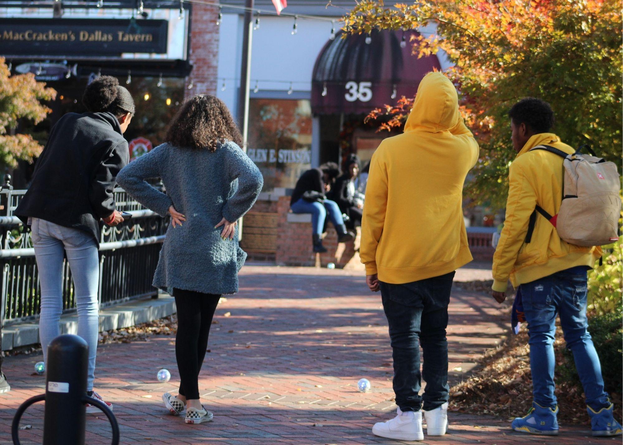 People standing outside a tavern, with an autumn scenery / KSU TRiO students learn basic programming concepts and different career options.