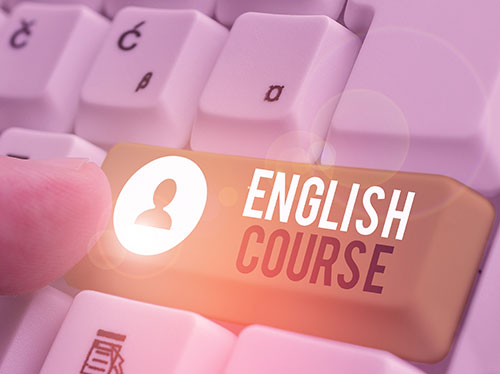 Close-up of a finger pressing a keyboard key labeled 'English Course,' symbolizing online or digital English language learning.