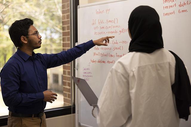 teacher and student at white board