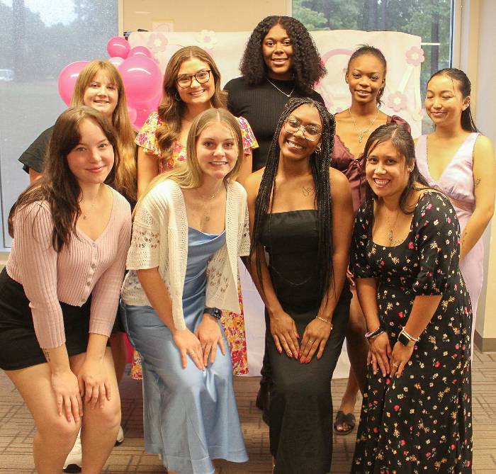 a large group of students in the bloom organization smiling for picture.