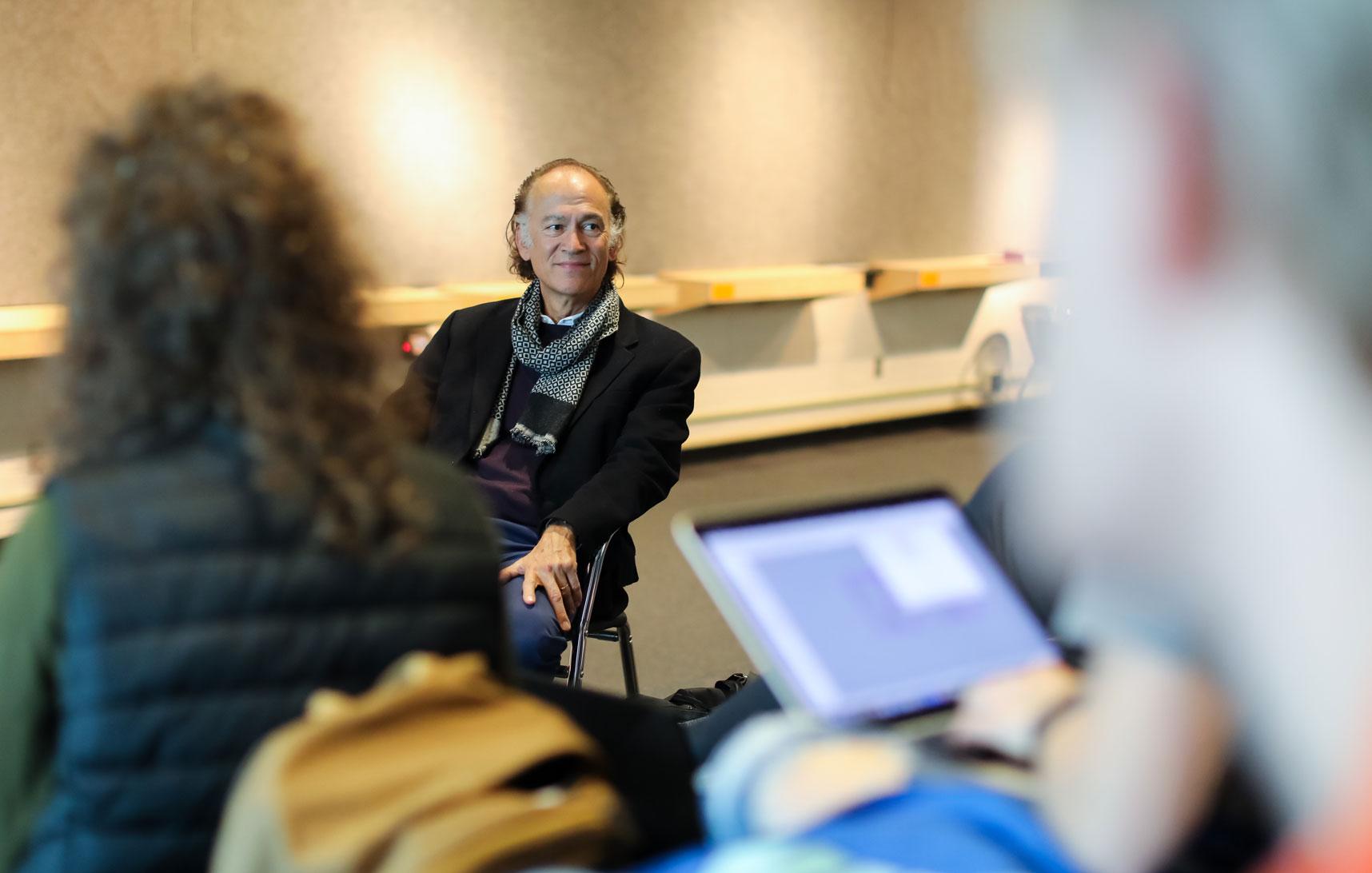  / Lecturer Turan Duda sitting  in a classroom 