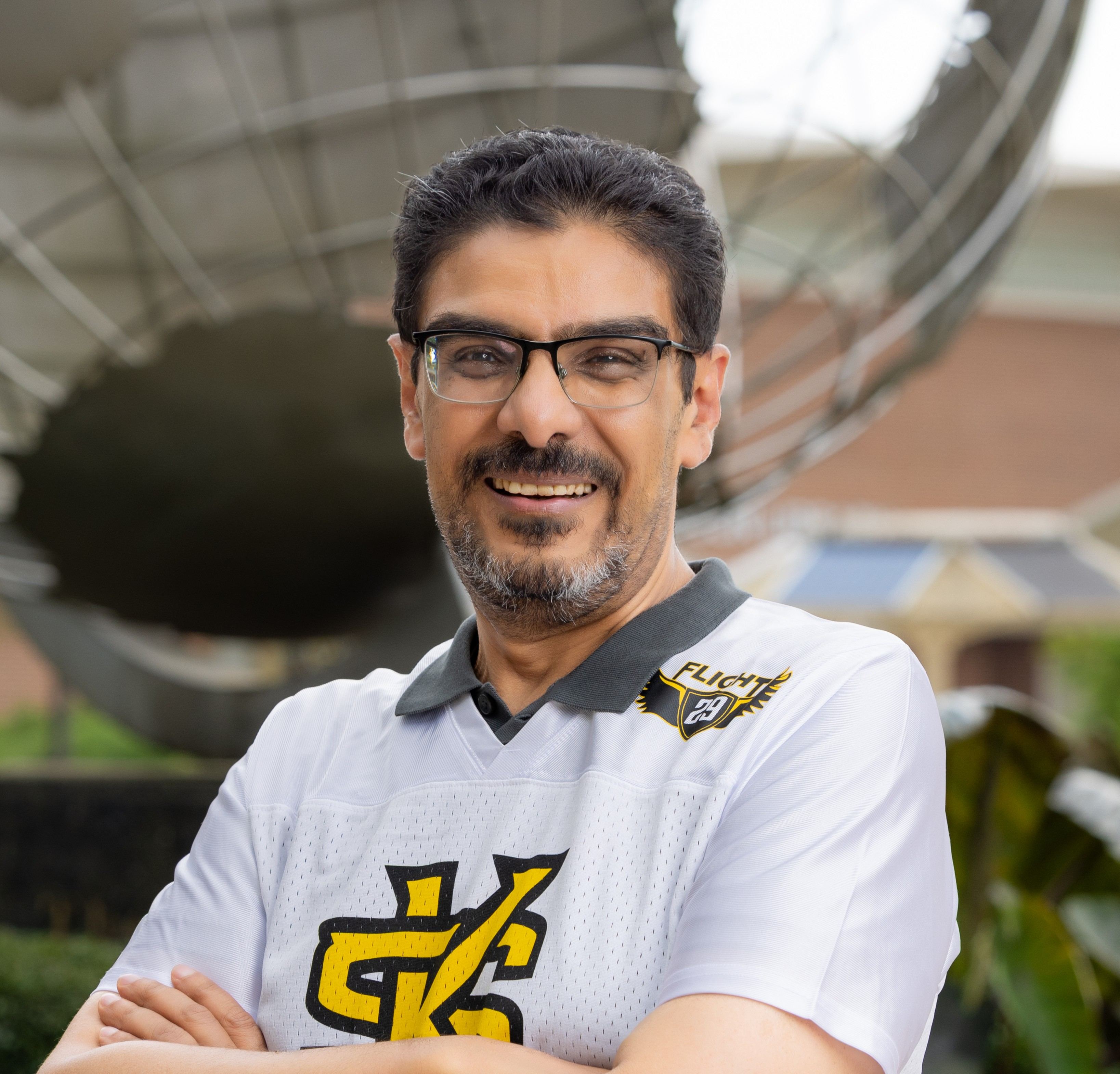 Hazem smiling in front of the Marietta Globe. 
