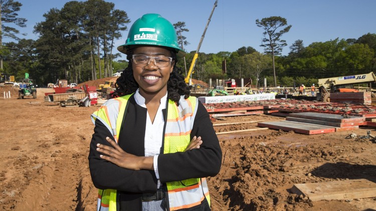 african american female in hard hat and googles on construction job site
