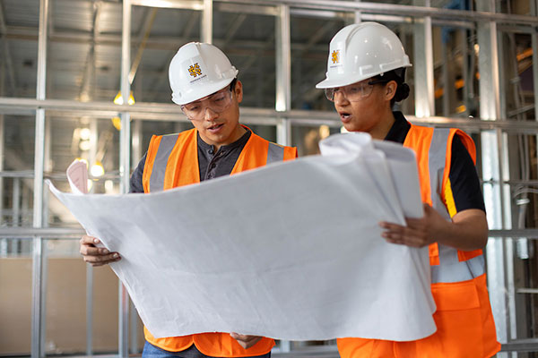 ksu construction management students on job site lookin at blueprints