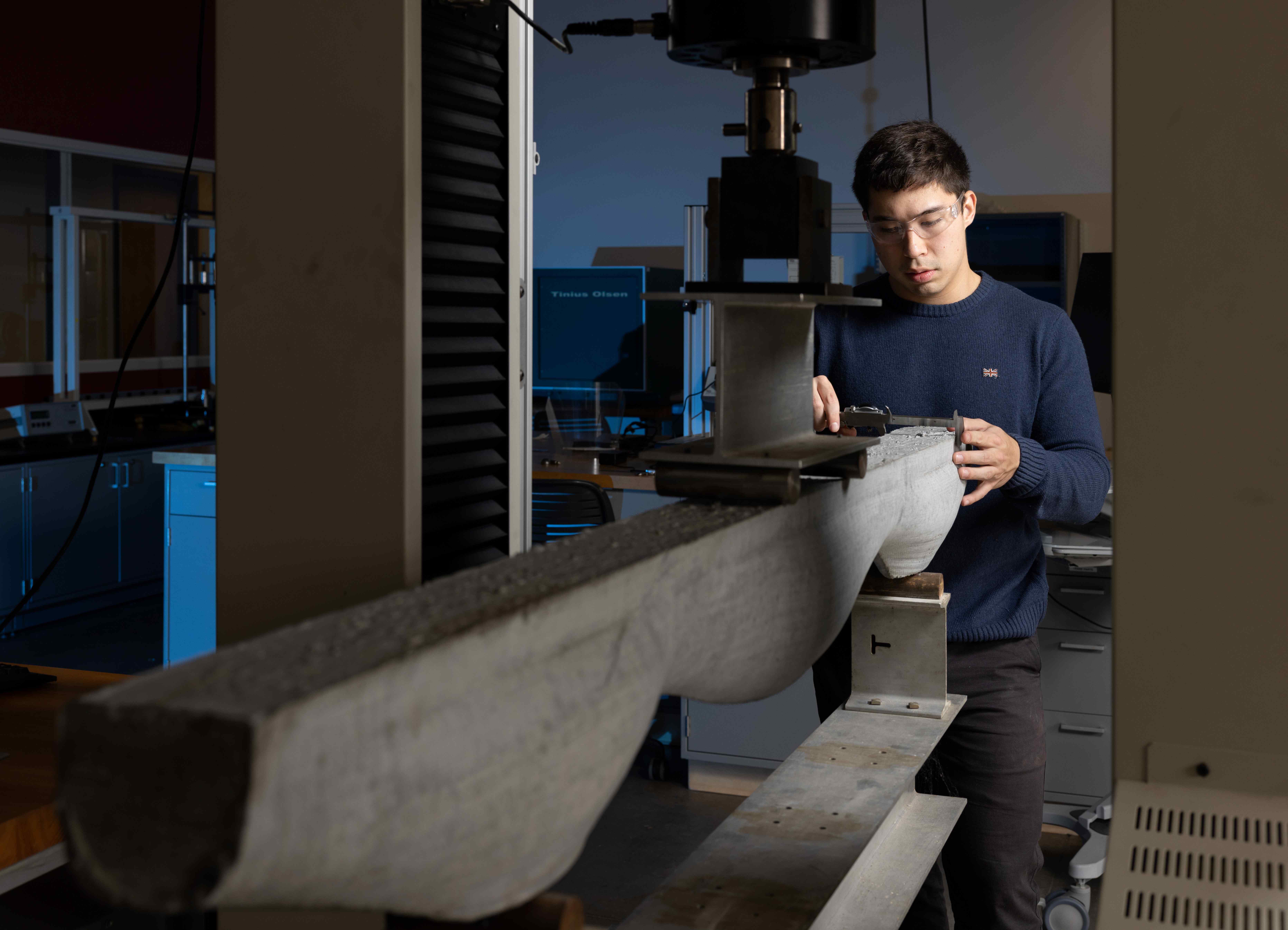 Student conducting concrete research in the lab. 