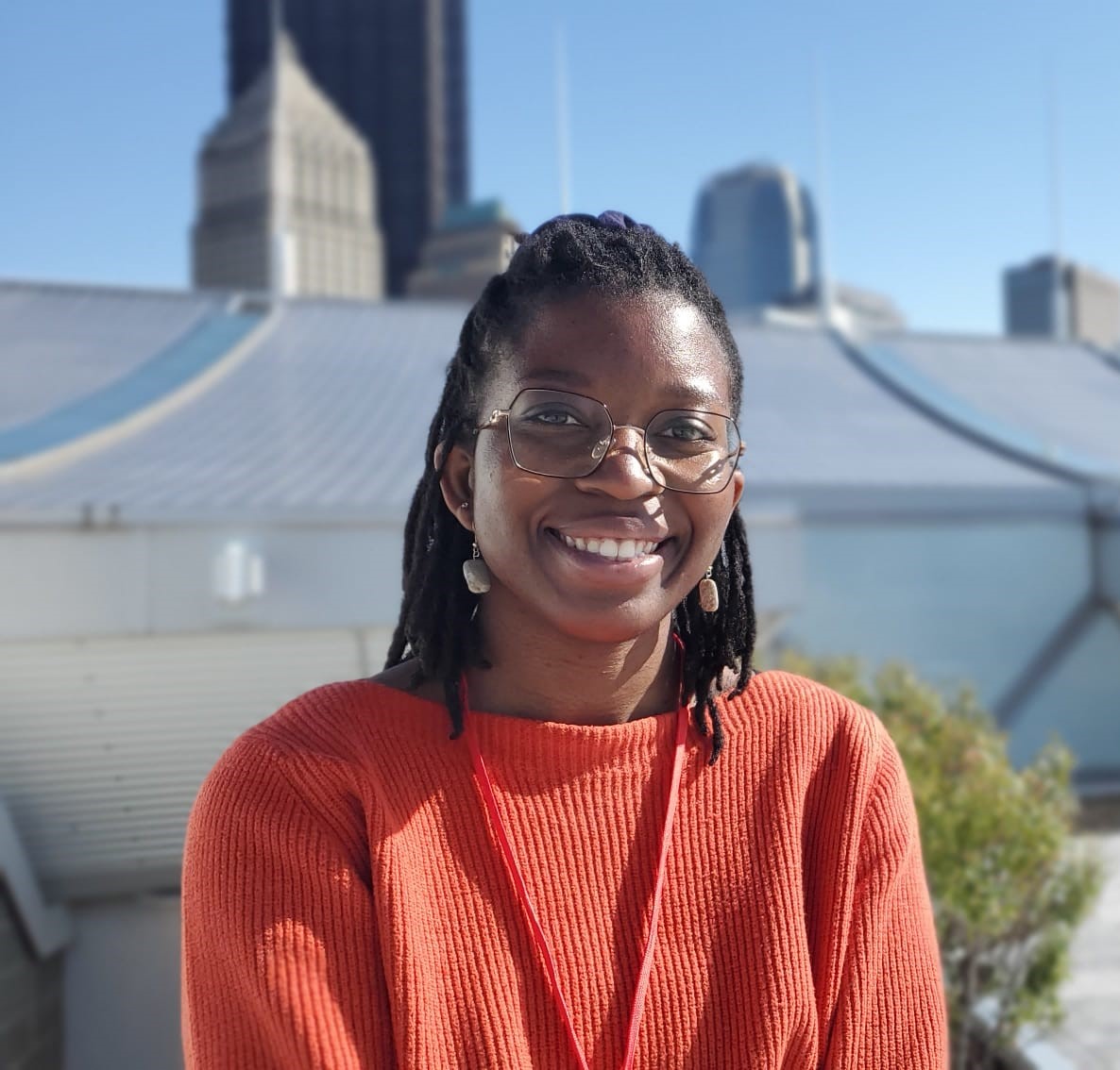 Mayowa Odunjo smiling in front of a city view.