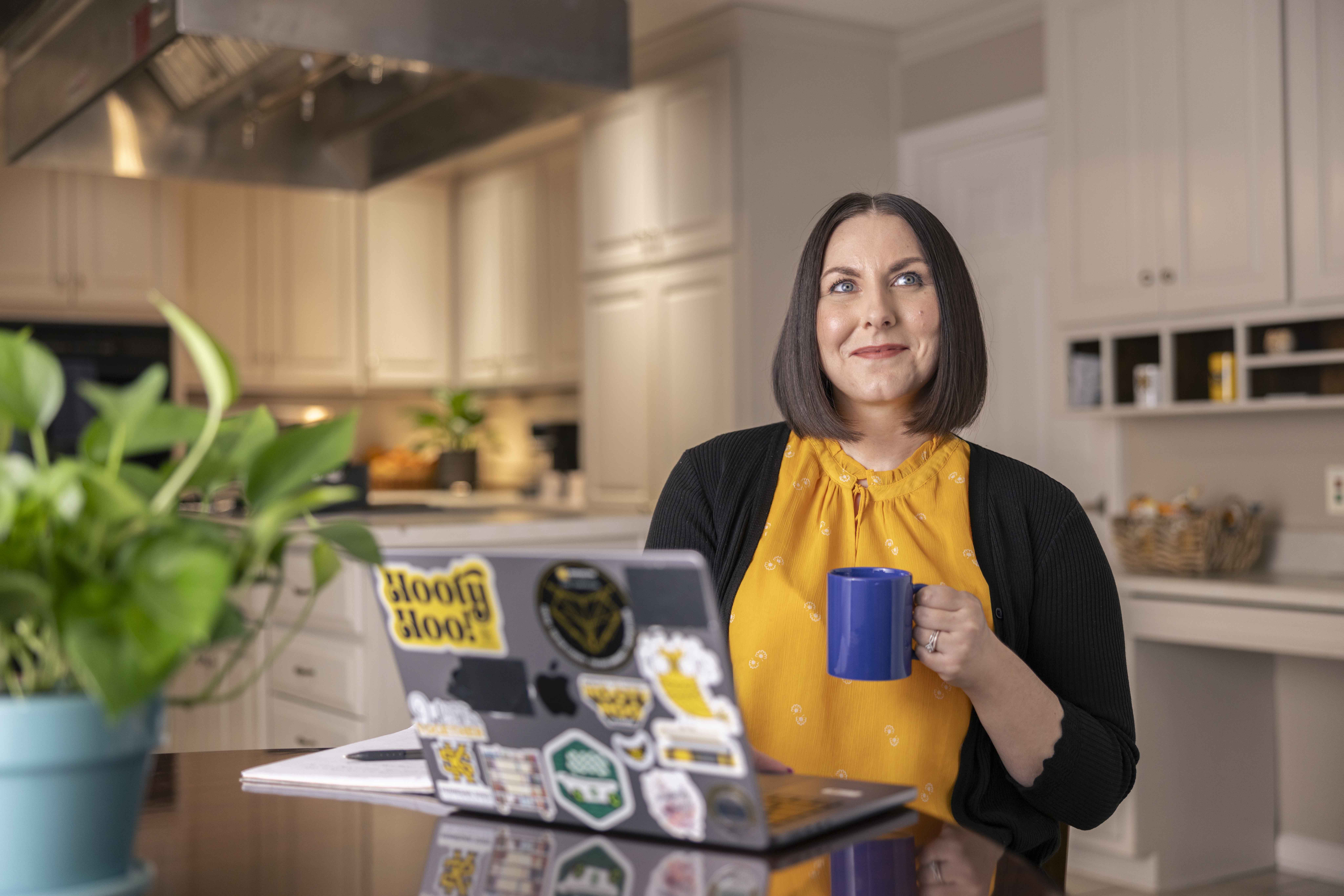 kennesaw state university faculty working from home on couch on laptop