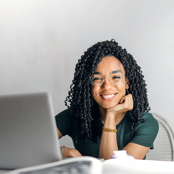 african american female smiling on computer doing work