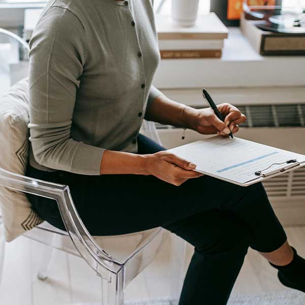 lady in office writing on chair