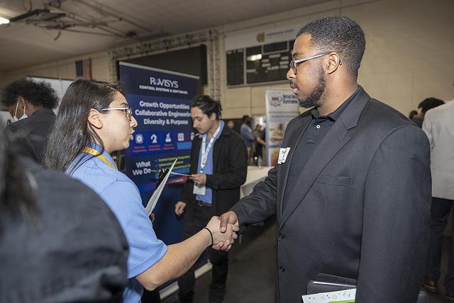 student accepting internship at job fair
