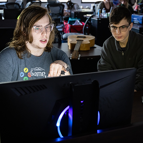 Two male students looking at a computer.