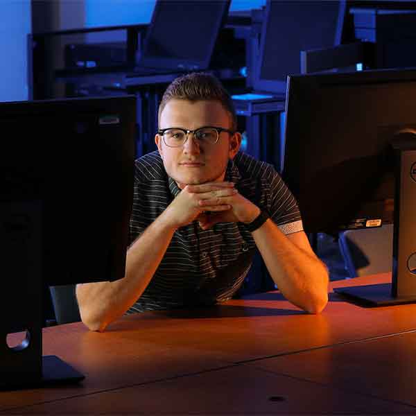 CCSE Information Technology student sitting at their desk.