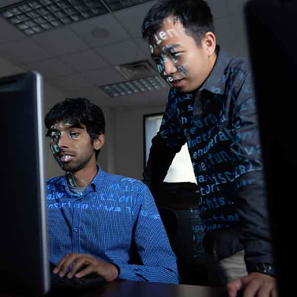 Two Software Engineering students focusing on the computer.