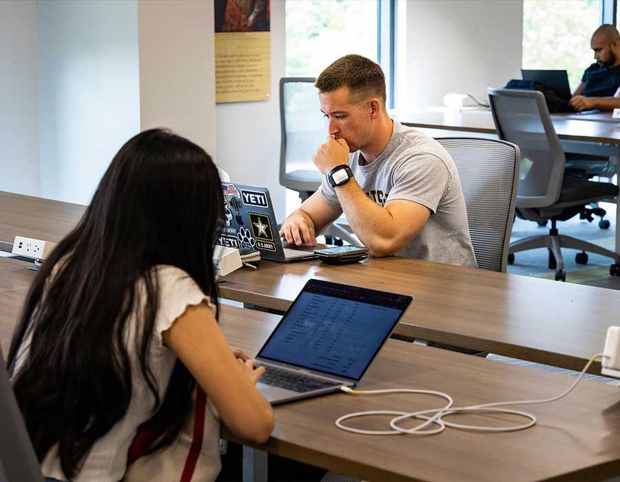 ksu students researching on their laptops.