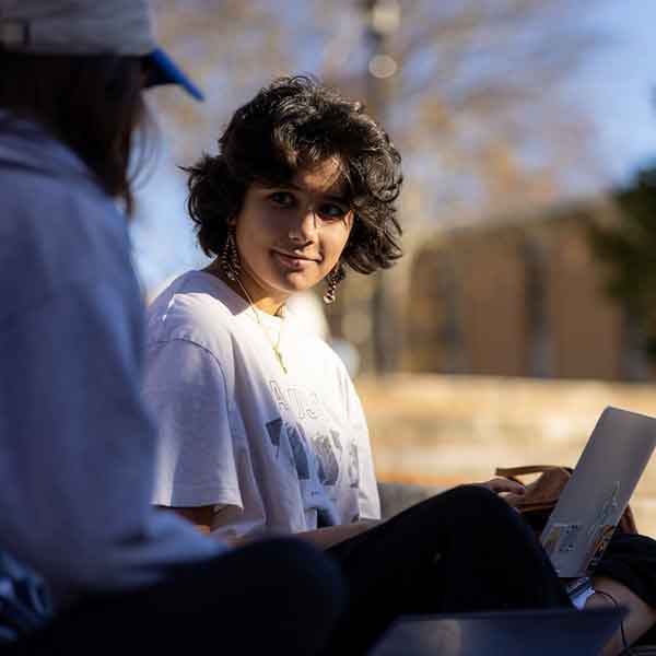 KSU Graduate student using their laptop.
