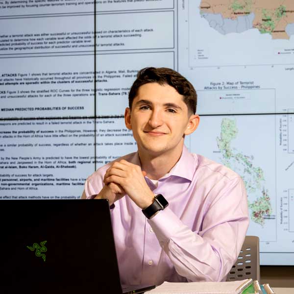 ksu data science student sitting at desk in front of laptop