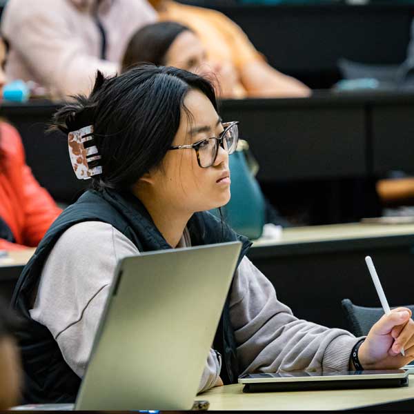 ksu information technology student taking notes in classroom